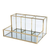 Glass makeup organizer with tiered compartments in luxury brass vanity style